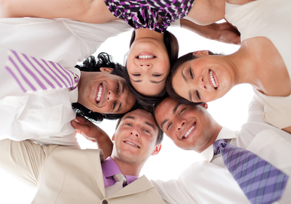 Smiling business team in a circle with heads together